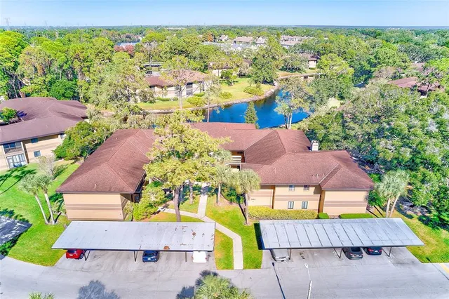 an aerial view of residential houses with outdoor space and swimming pool
