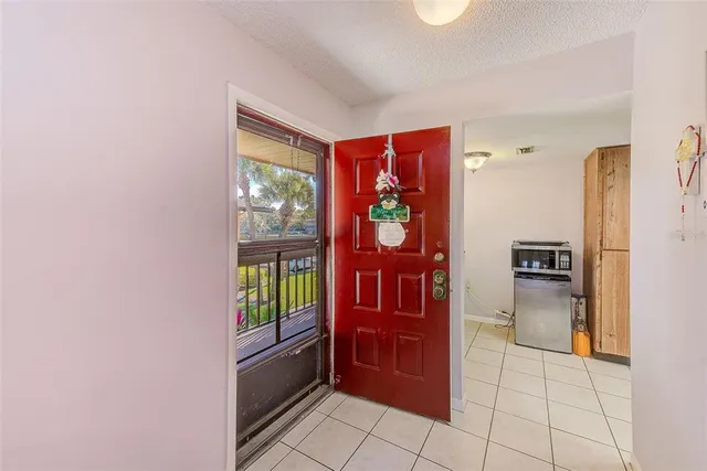 a kitchen with granite countertop a refrigerator and a sink