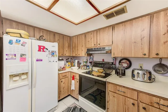 a white refrigerator freezer sitting in a kitchen