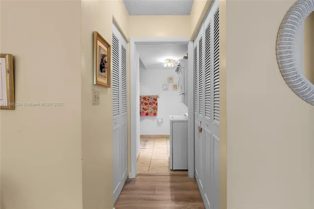 a view of a hallway with wooden floor