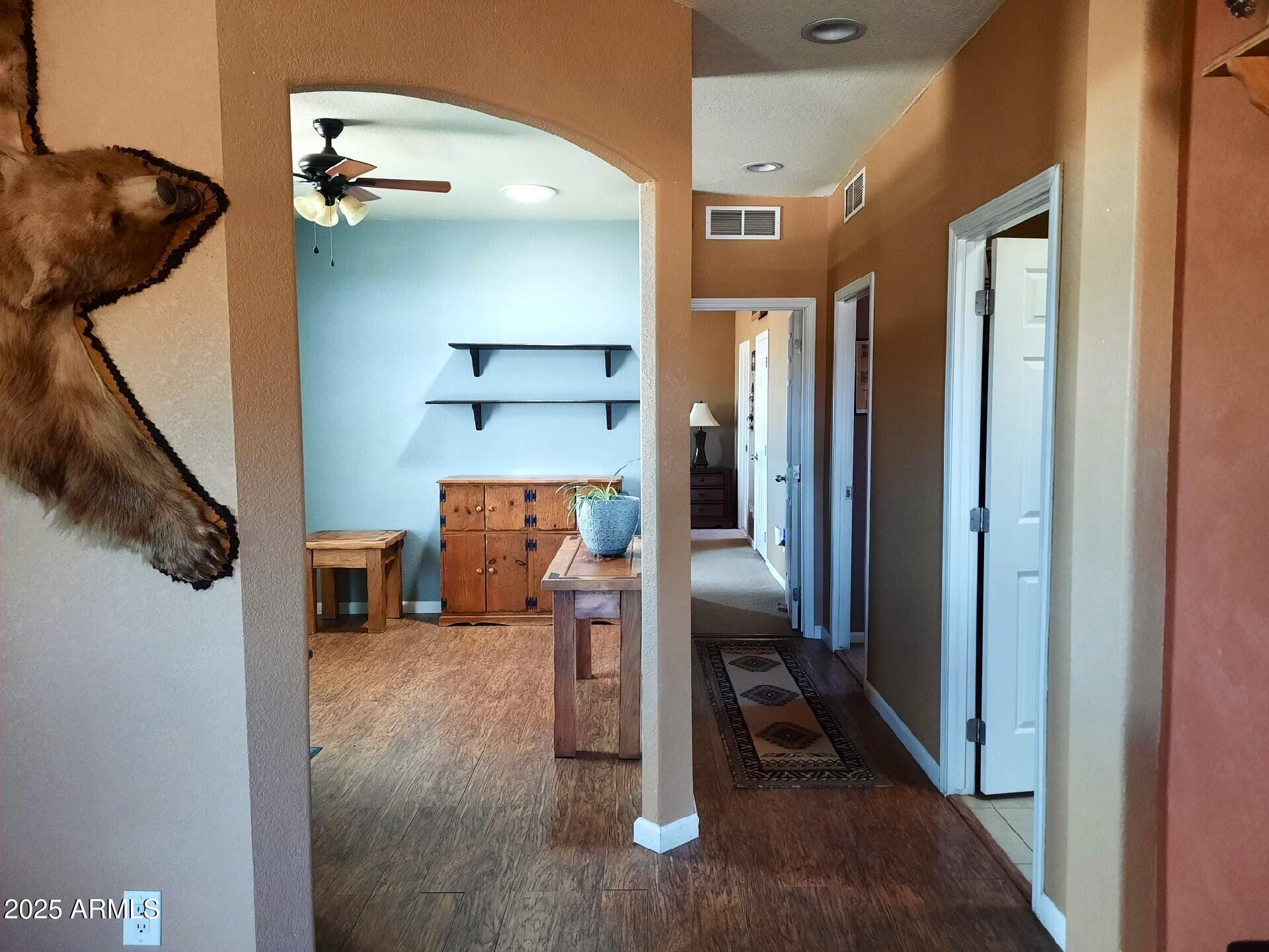 74 N7121 Red Sky Ranch St. Johns, AZ 85936 - Photo 31 of 65 a view of a hallway with wooden floor and staircase