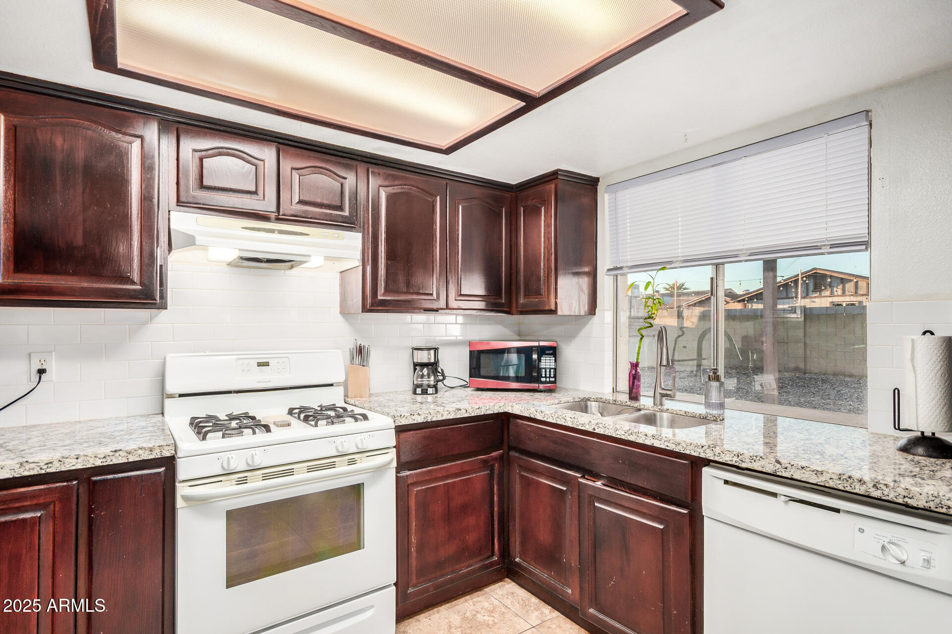 1634 West Villa Rita Drive Phoenix, AZ 85023 - Photo 23 of 47 a kitchen with stainless steel appliances granite countertop a stove sink and cabinets