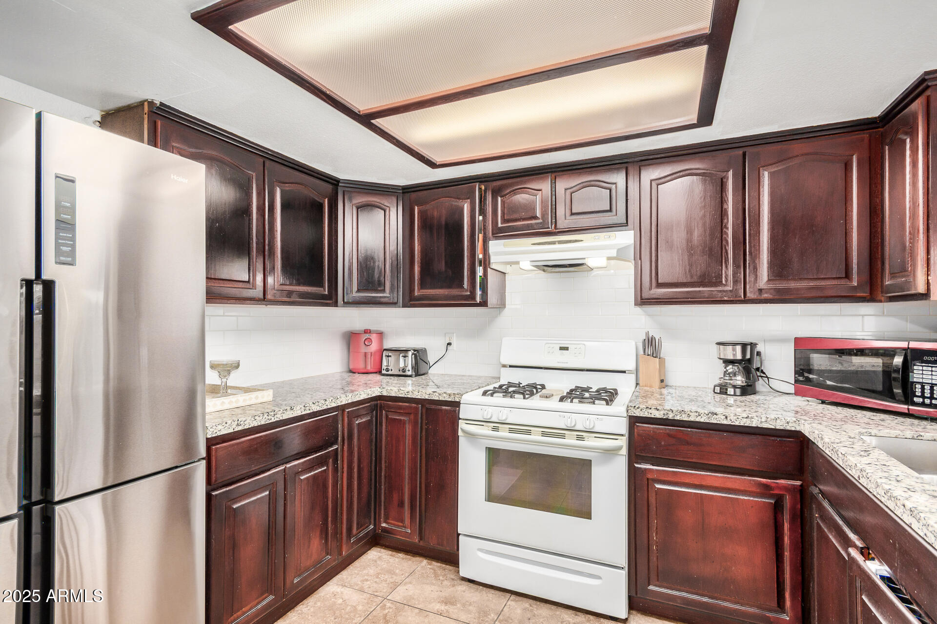 1634 West Villa Rita Drive Phoenix, AZ 85023 - Photo 24 of 47 a kitchen with stainless steel appliances granite countertop a stove sink and refrigerator