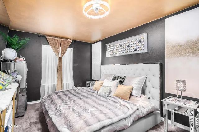 a bedroom with a bed and a tv in it