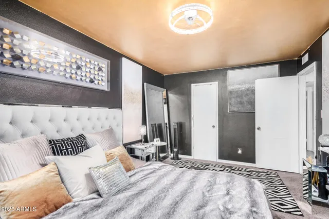 a bedroom with a bed and a chandelier