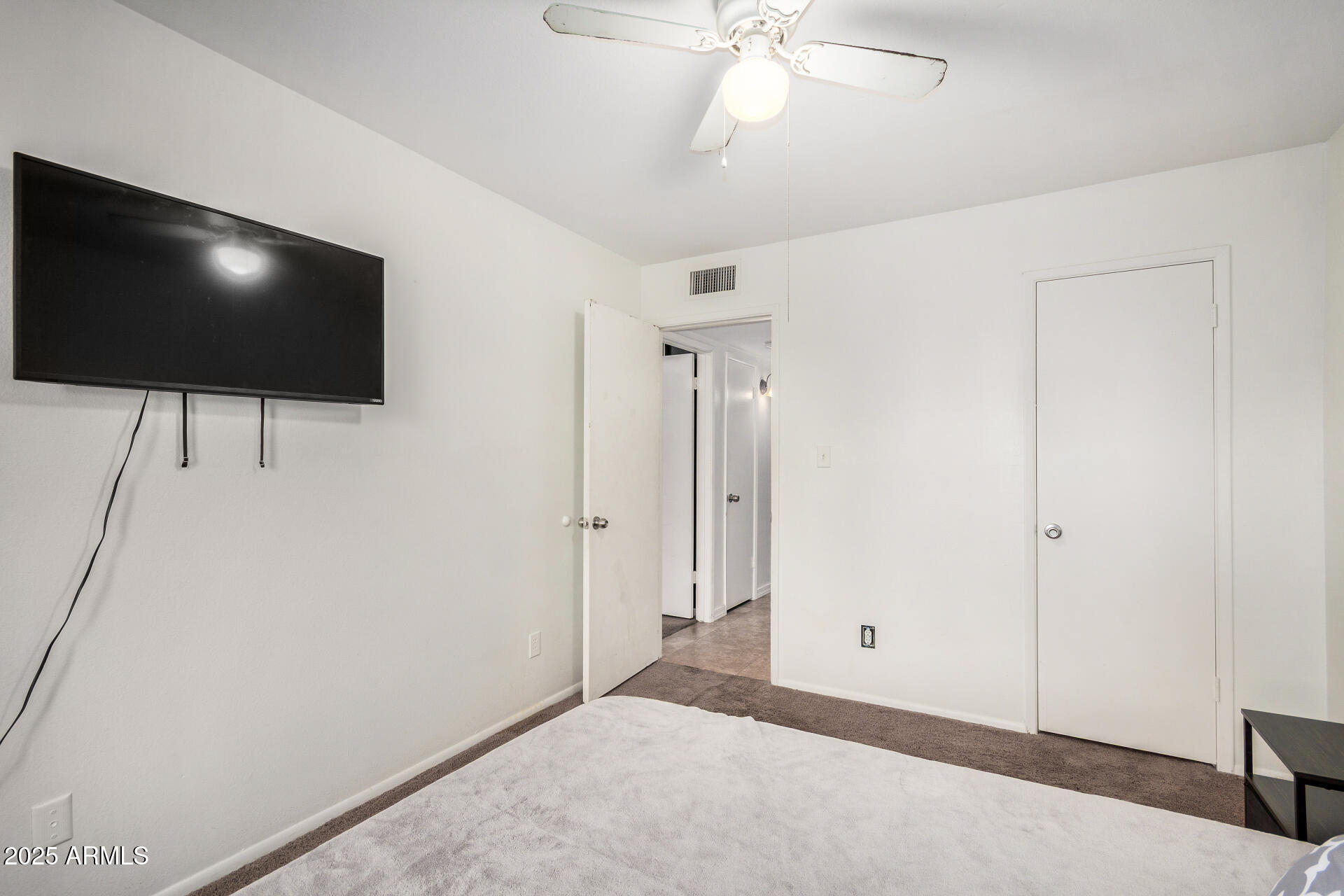 1634 West Villa Rita Drive Phoenix, AZ 85023 - Photo 34 of 47 a living room with flat screen tv and a ceiling fan