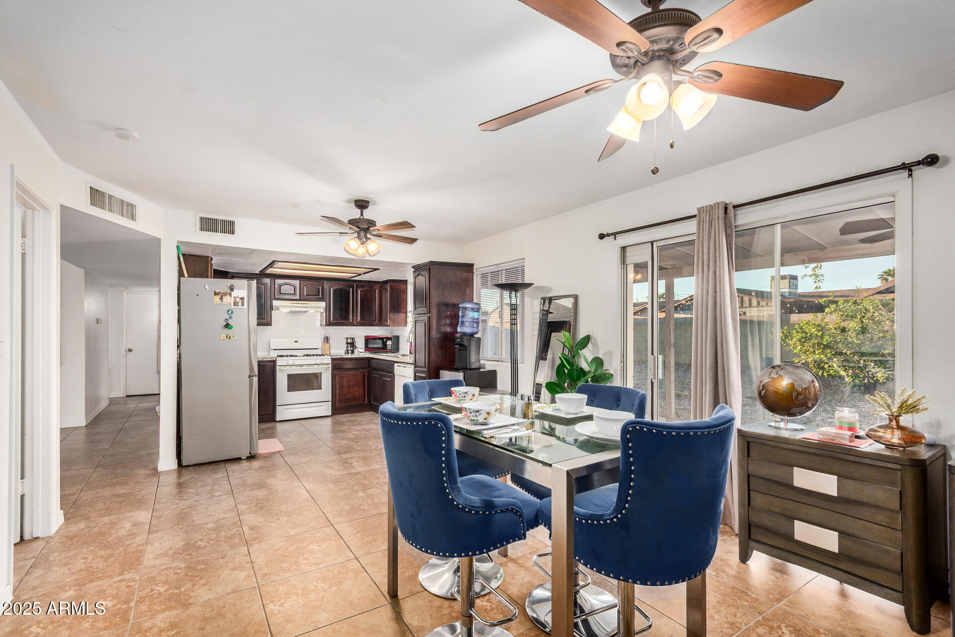 1634 West Villa Rita Drive Phoenix, AZ 85023 - Photo 6 of 47 a dining room with furniture a chandelier and a large window