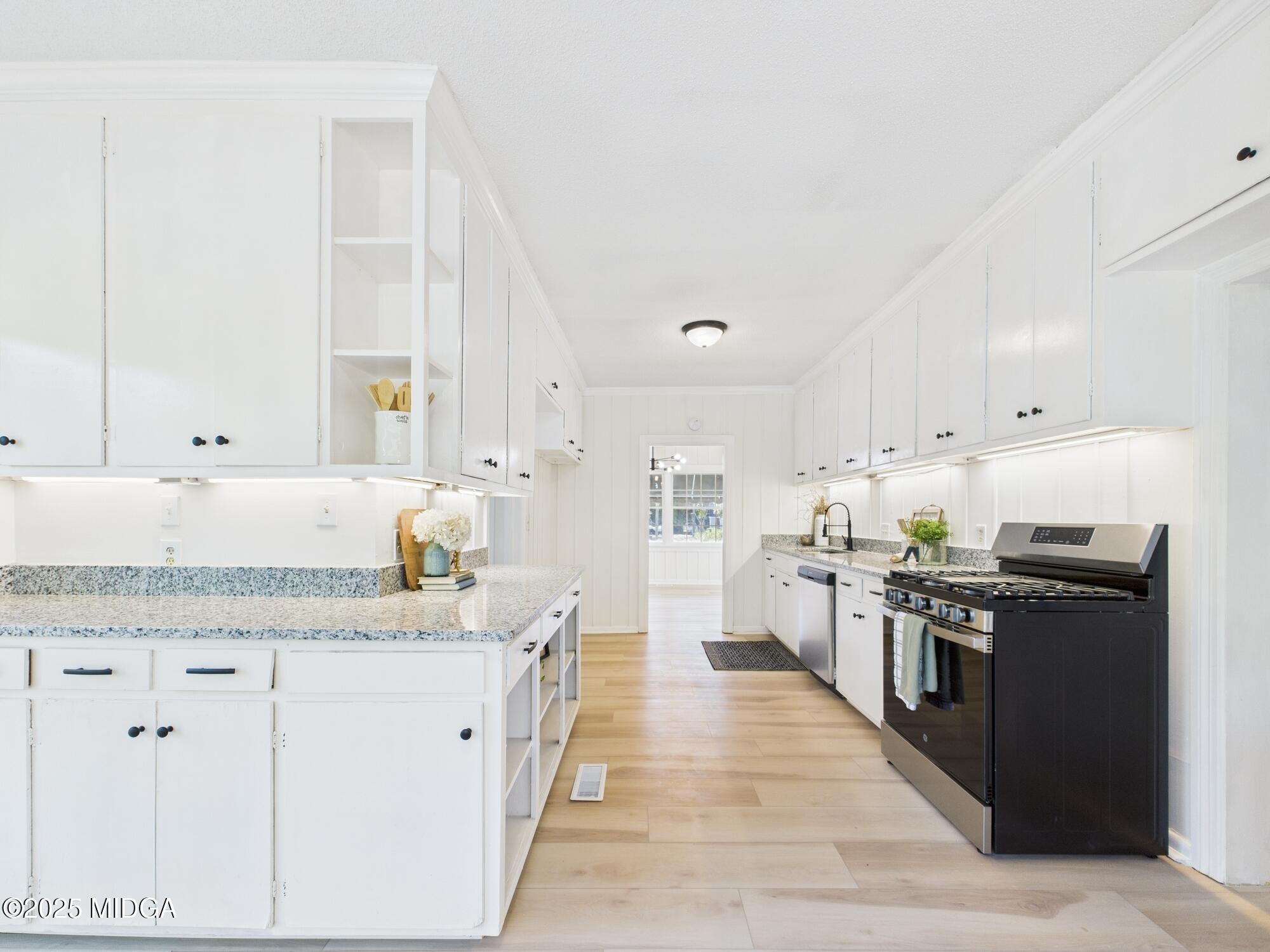 621 Forest Hill Road Macon, GA 31210 - Photo 11 of 50 a kitchen with stainless steel appliances granite countertop a stove top oven a sink a counter space and cabinets