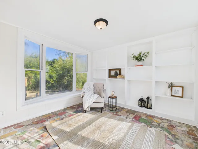 a living room with furniture and a window