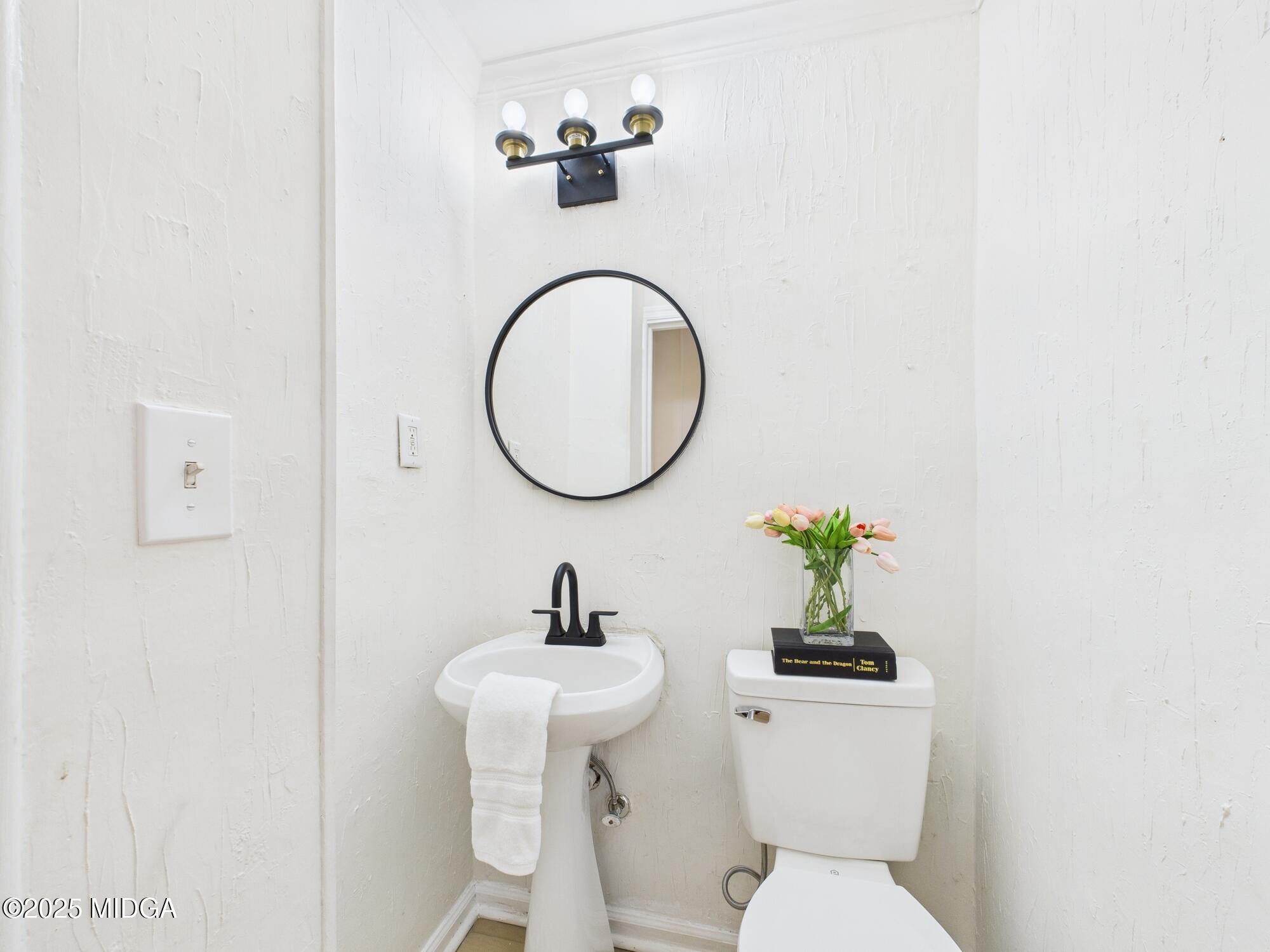 621 Forest Hill Road Macon, GA 31210 - Photo 23 of 50 a bathroom with a toilet sink and mirror
