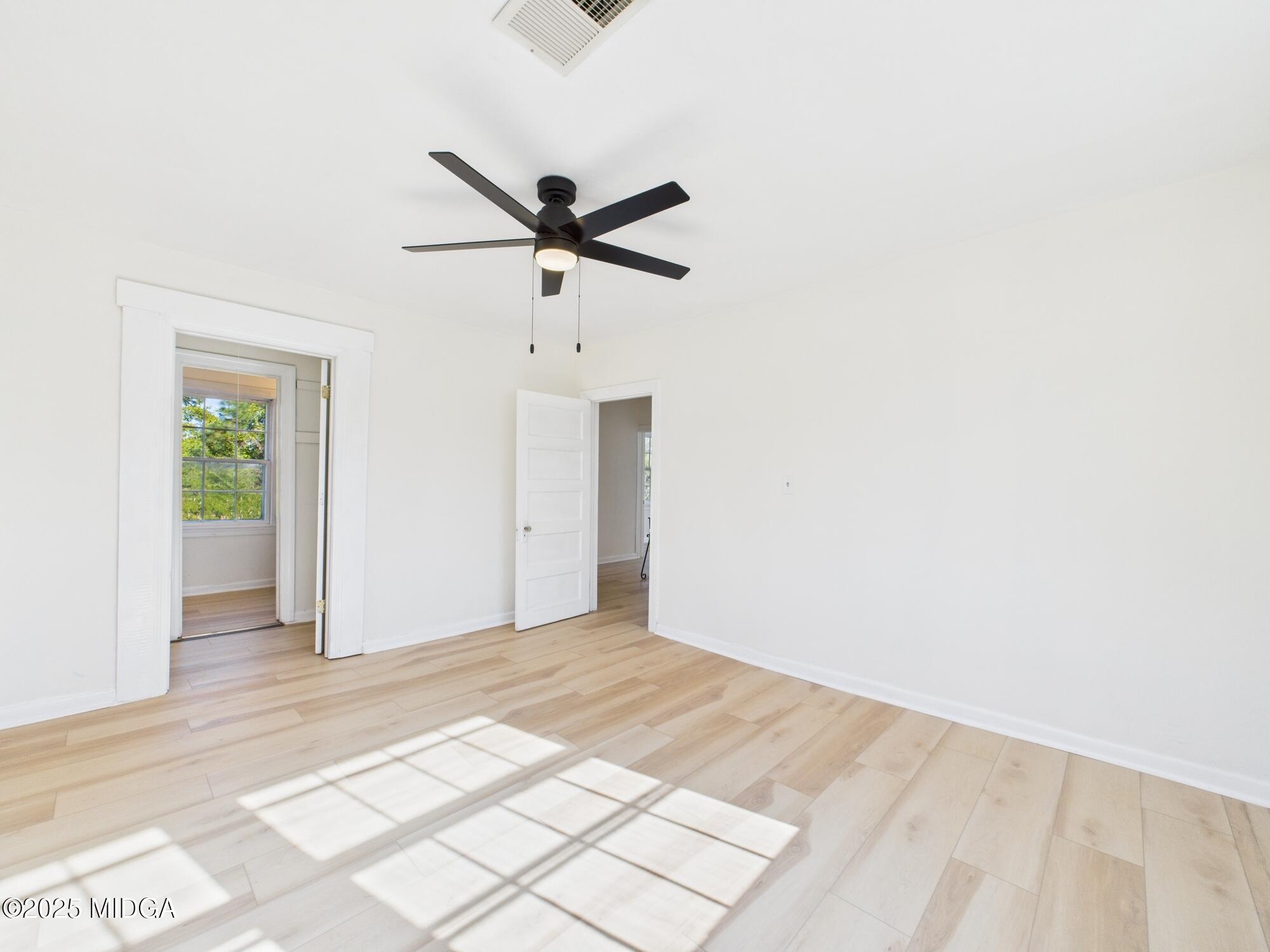 621 Forest Hill Road Macon, GA 31210 - Photo 27 of 50 an empty room with closet and a ceiling fan