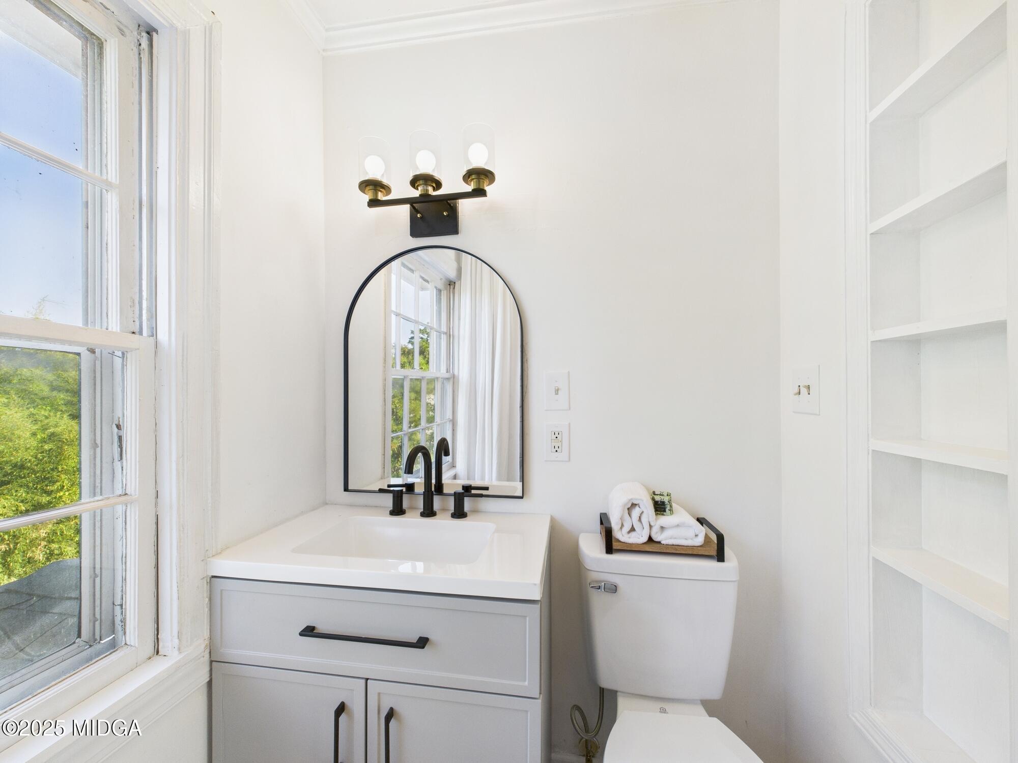 621 Forest Hill Road Macon, GA 31210 - Photo 29 of 50 a bathroom with a toilet sink and mirror