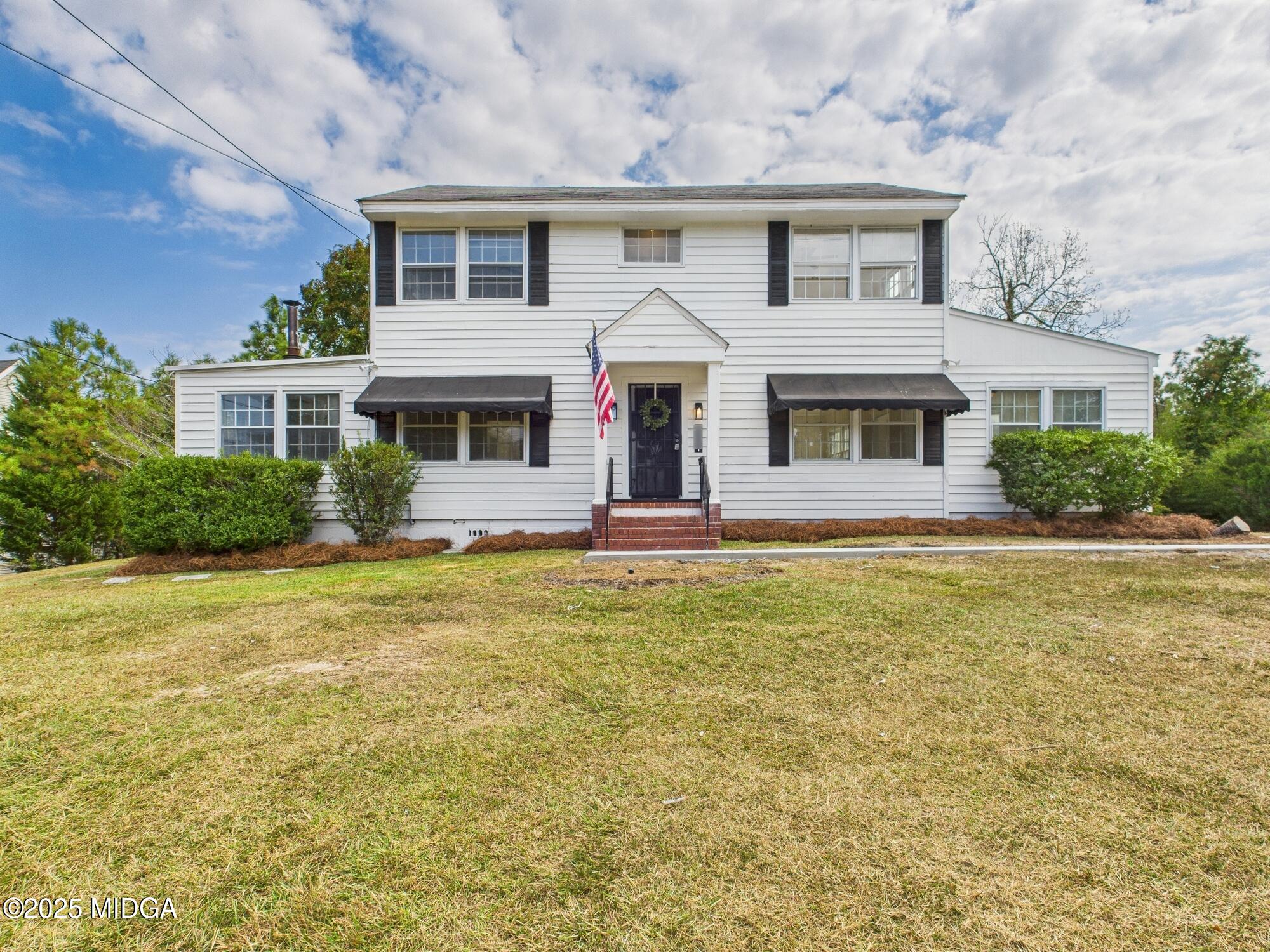 621 Forest Hill Road Macon, GA 31210 - Photo 3 of 50 a front view of a house with yard and garage