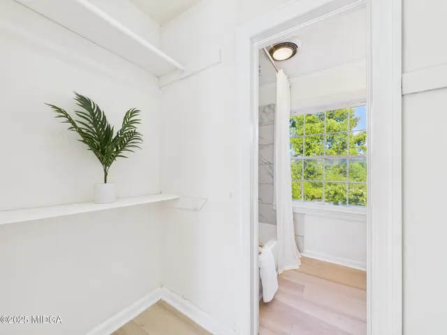 a view of a big room with wooden floor and closet