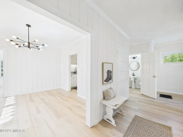 a large white kitchen with cabinets