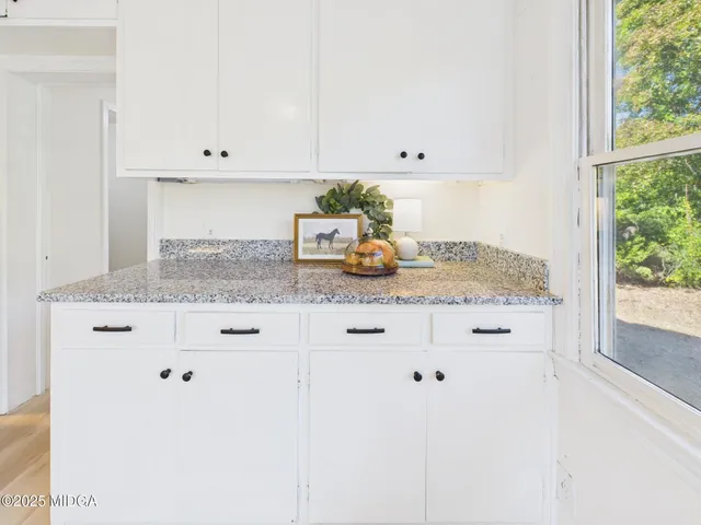 a kitchen with stainless steel appliances granite countertop a stove top oven a sink a counter space and cabinets