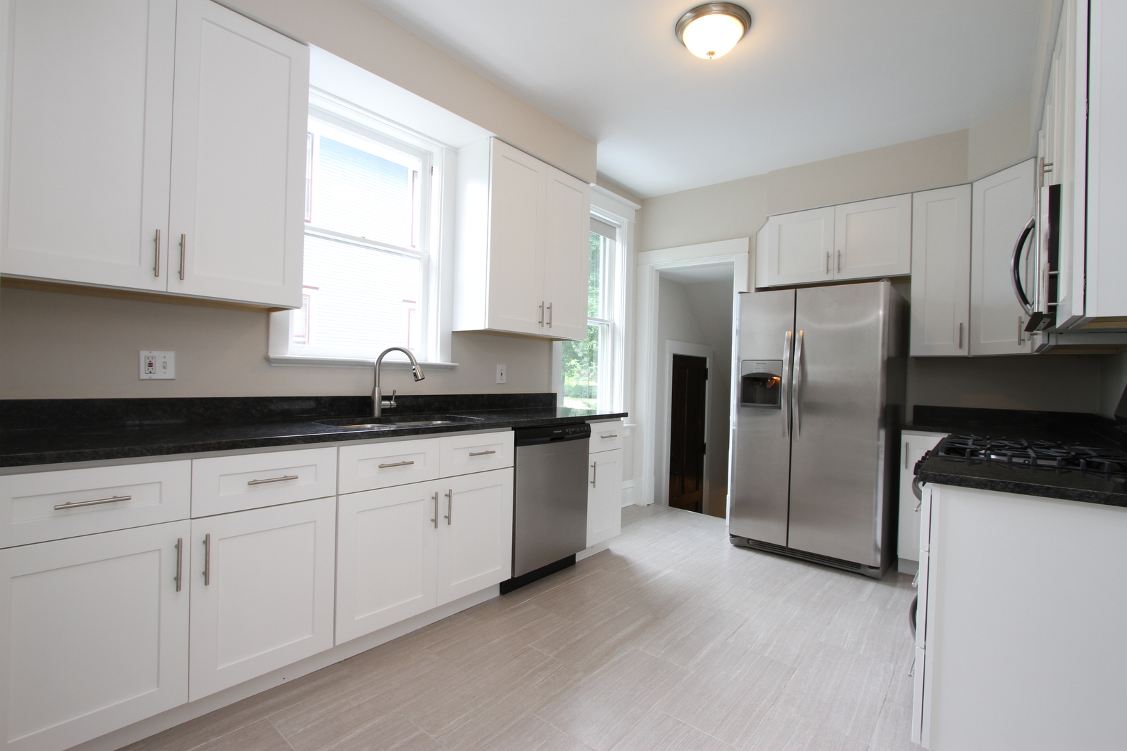 910 North Spring Street Elgin, IL 60120 - Photo 12 of 34 a kitchen with granite countertop a refrigerator sink and cabinets