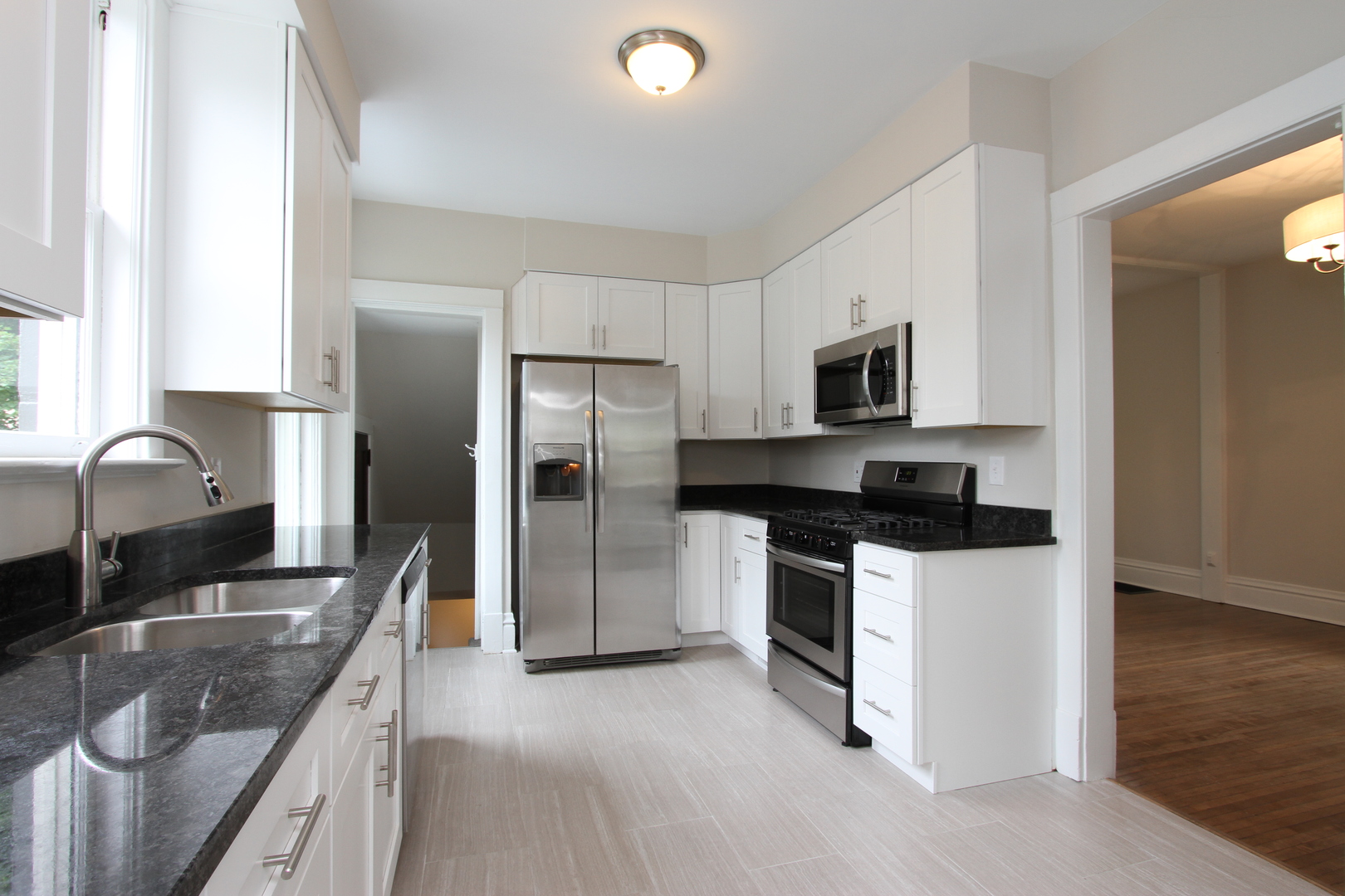 910 North Spring Street Elgin, IL 60120 - Photo 13 of 34 a kitchen with stainless steel appliances granite countertop a sink stove and refrigerator