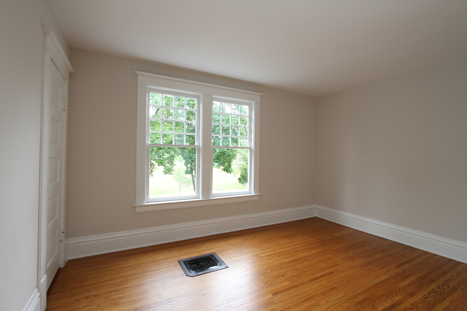 910 North Spring Street Elgin, IL 60120 - Photo 16 of 34 an empty room with wooden floor and windows