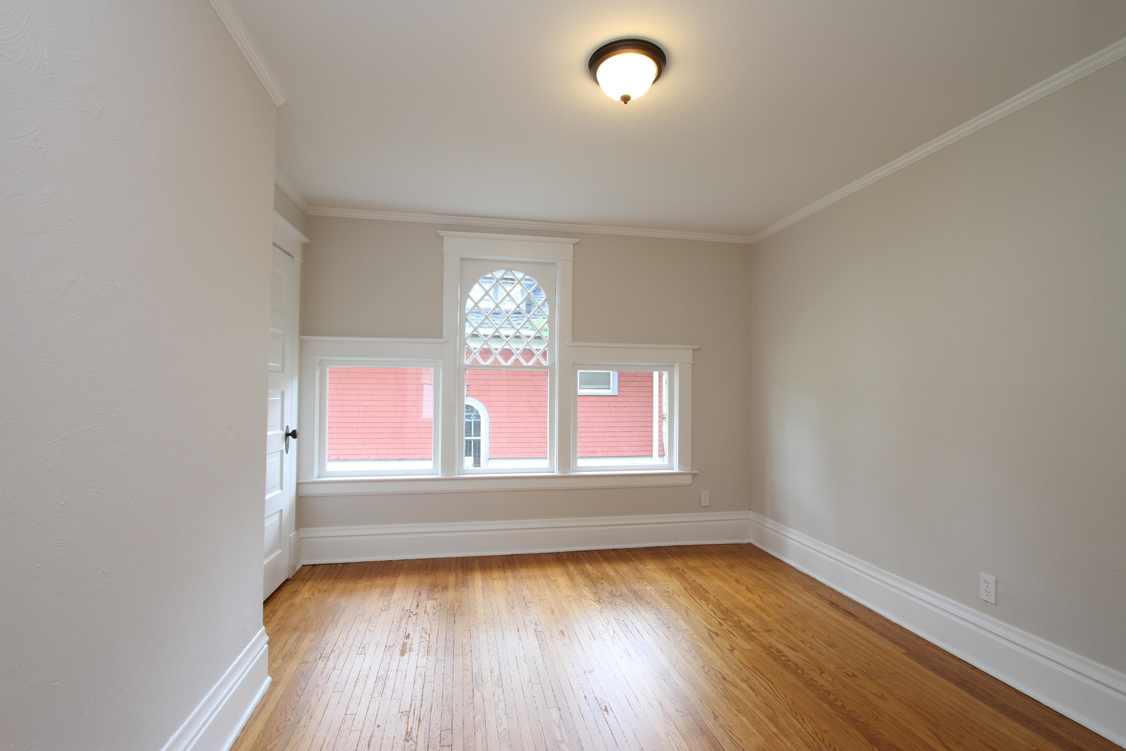 910 North Spring Street Elgin, IL 60120 - Photo 18 of 34 an empty room with wooden floor and windows