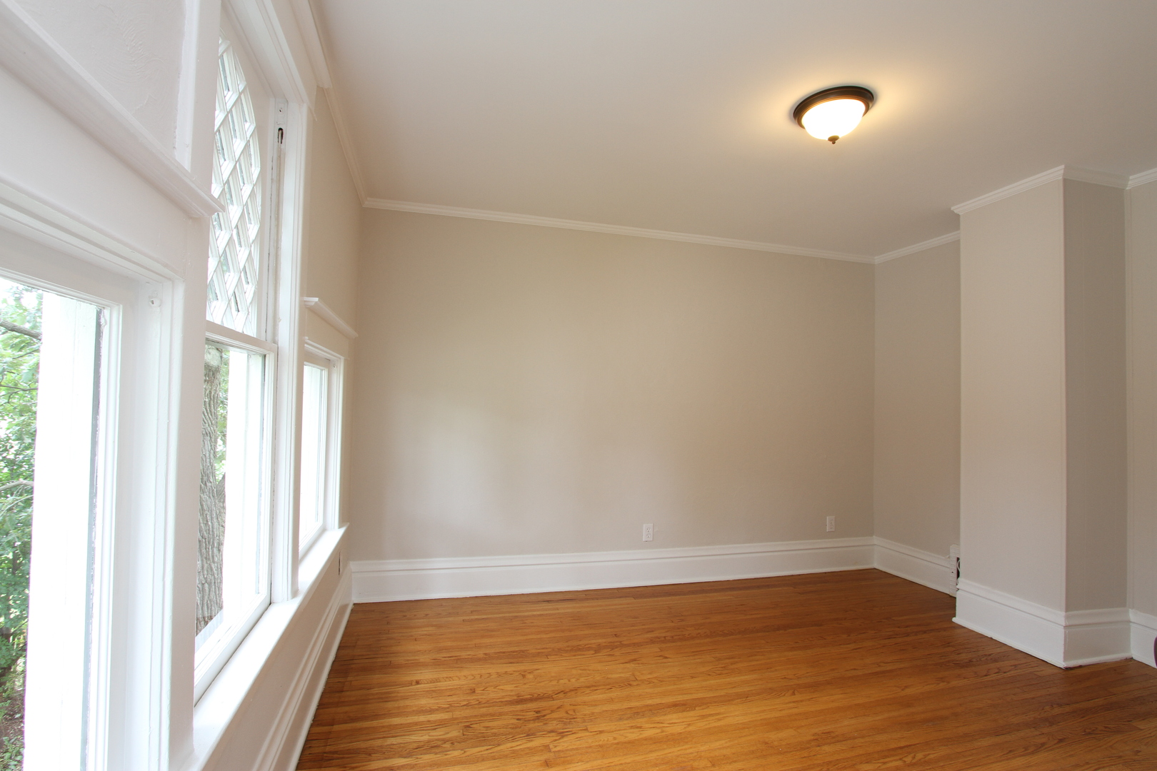 910 North Spring Street Elgin, IL 60120 - Photo 19 of 34 a view of an empty room with wooden floor and a window