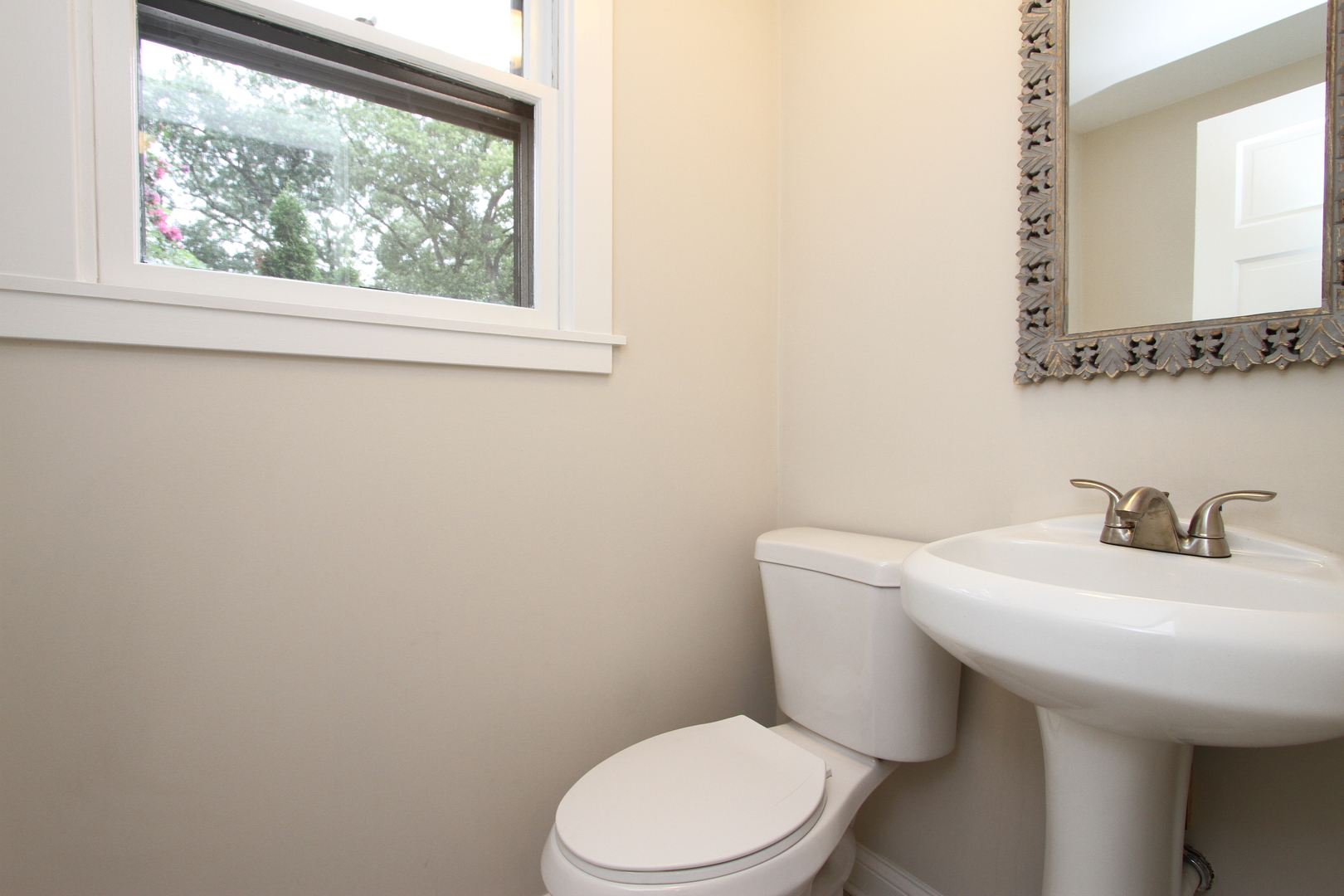 910 North Spring Street Elgin, IL 60120 - Photo 26 of 34 a white toilet sitting next to a bathroom sink