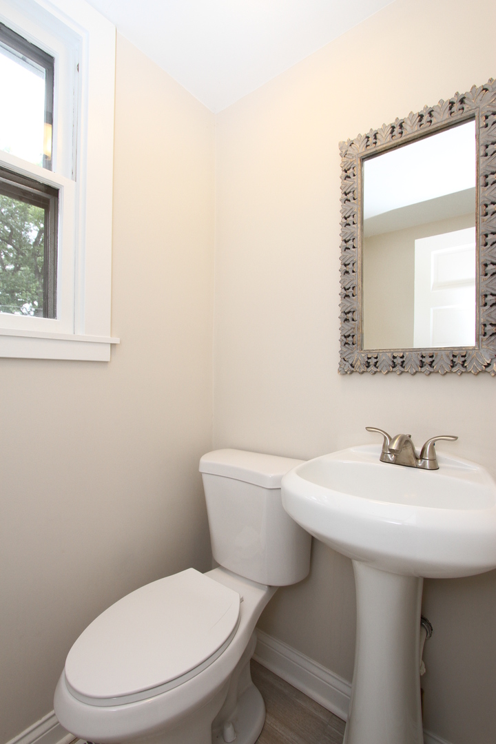 910 North Spring Street Elgin, IL 60120 - Photo 27 of 34 a white toilet sitting next to a bathroom sink