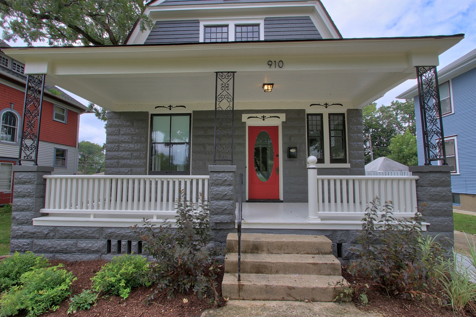 910 North Spring Street Elgin, IL 60120 - Photo 3 of 34 a front view of a house with a garden