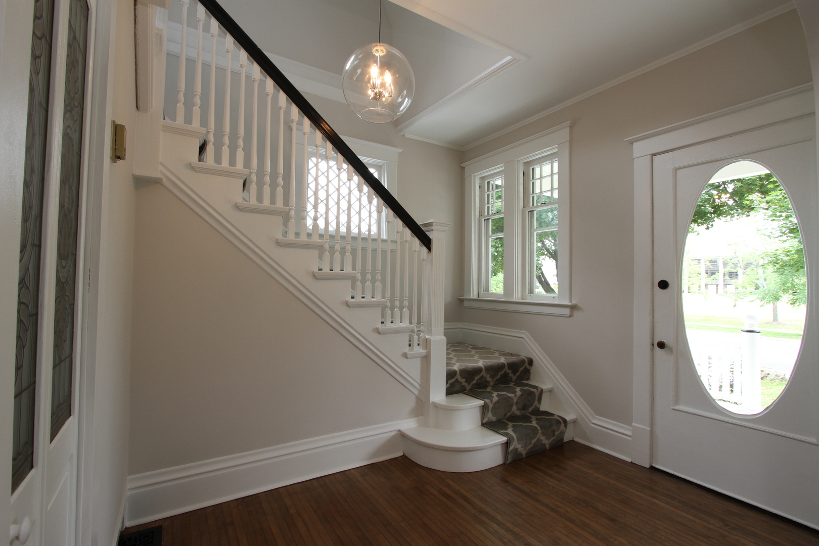 910 North Spring Street Elgin, IL 60120 - Photo 6 of 34 a view of entryway with wooden floor and stairs