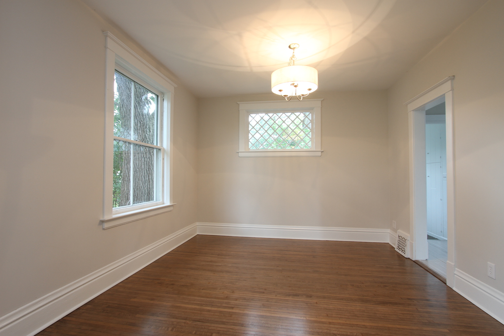 910 North Spring Street Elgin, IL 60120 - Photo 10 of 34 an empty room with wooden floor and windows