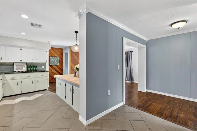 a kitchen with cabinets and wooden floor