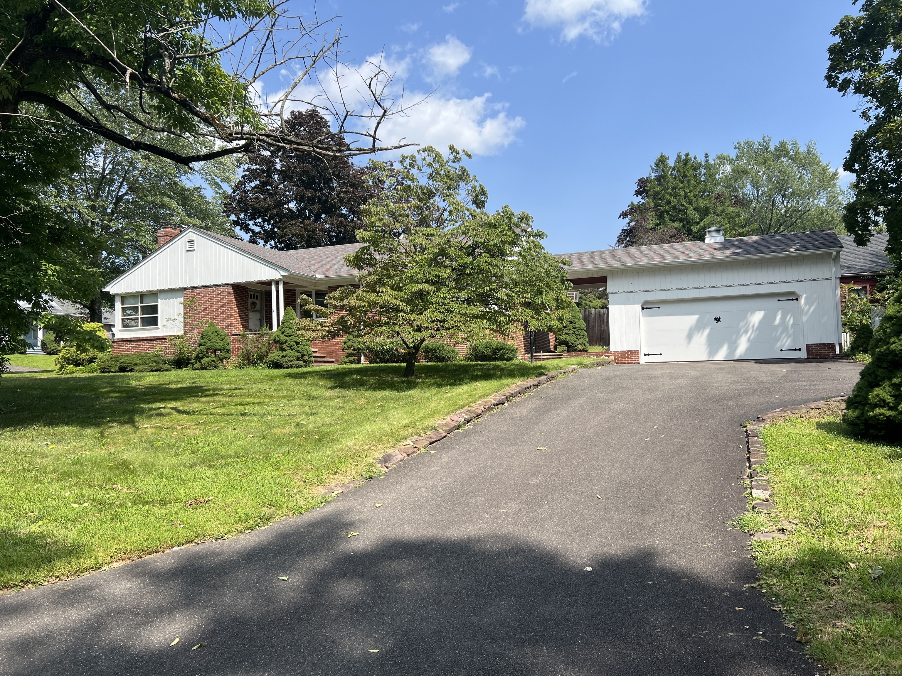a front view of house with yard and green space