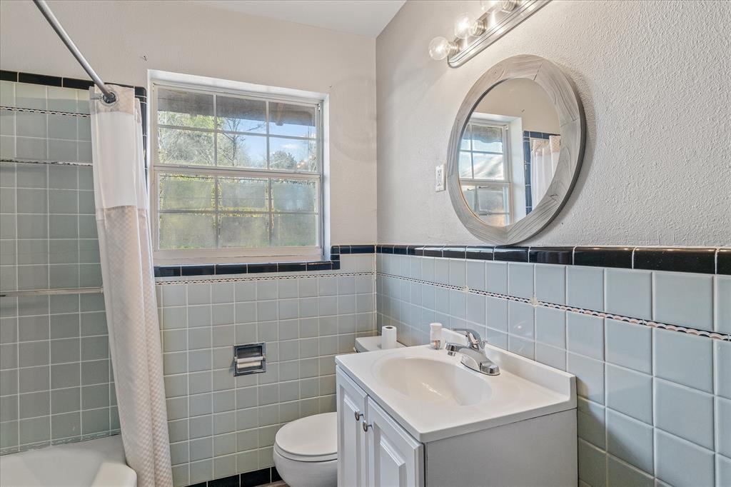 175 East Elm Street Canton, TX 75103 - Photo 16 of 25 a bathroom with a sink a toilet and a mirror