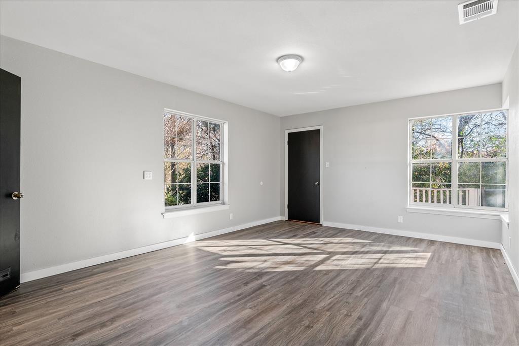 175 East Elm Street Canton, TX 75103 - Photo 17 of 25 a view of an empty room with wooden floor and a window