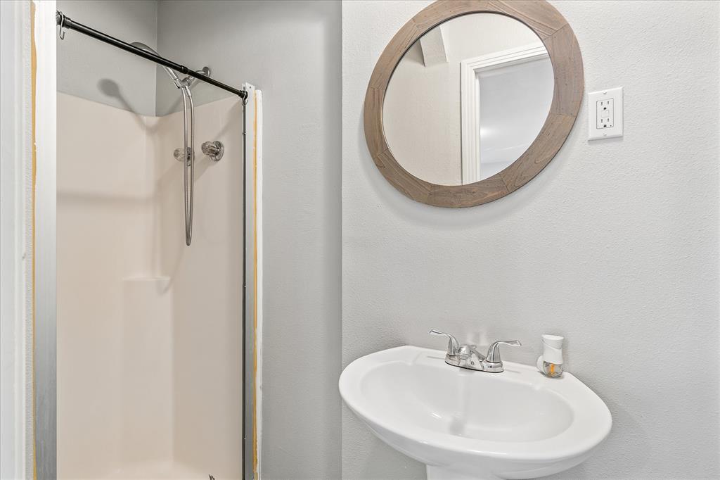 175 East Elm Street Canton, TX 75103 - Photo 19 of 25 a bathroom with a sink and a mirror