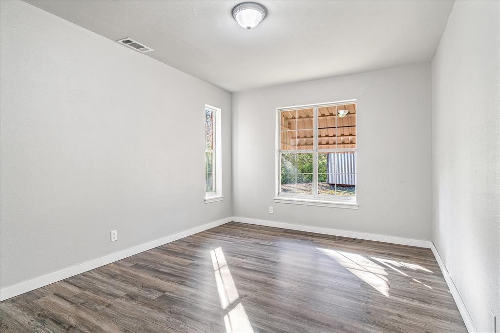 175 East Elm Street Canton, TX 75103 - Photo 22 of 25 a view of a room with wooden floor and windows in it
