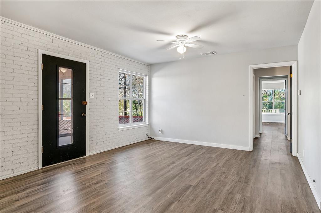 175 East Elm Street Canton, TX 75103 - Photo 3 of 25 a view of an empty room with wooden floor and a window