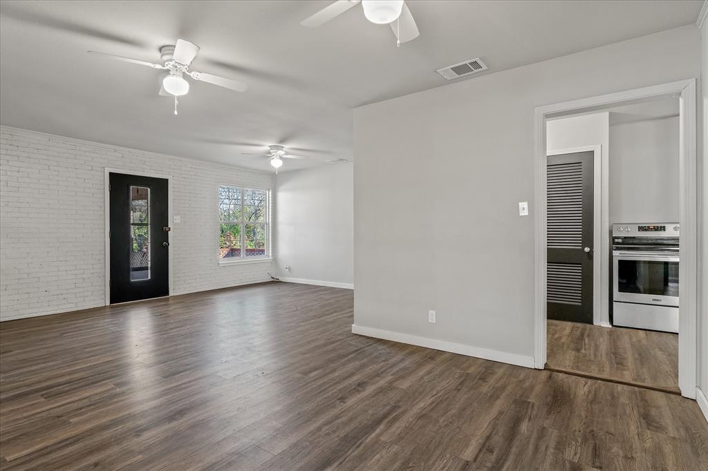 175 East Elm Street Canton, TX 75103 - Photo 6 of 25 an empty room with wooden floor ceiling fan and windows