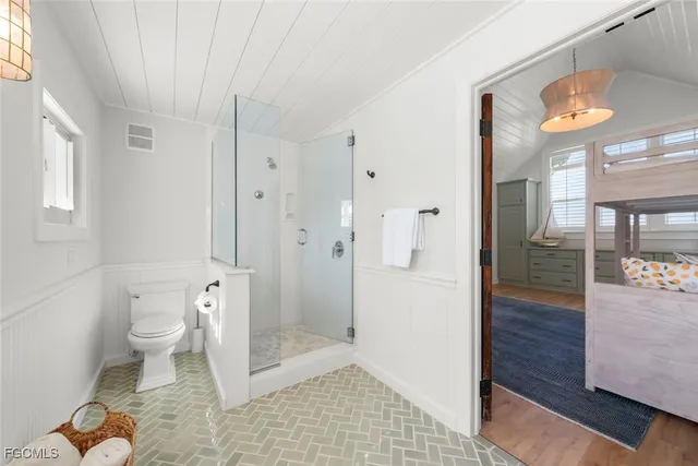 a bathroom with a toilet and a shower