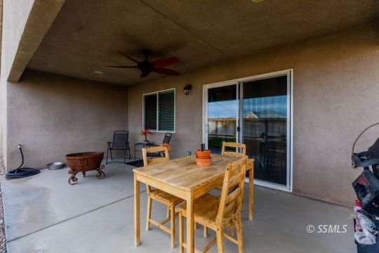 916 South Farragut Street Ridgecrest, CA 93555 - Photo 28 of 30 a view of a patio with a table and chairs and potted plants