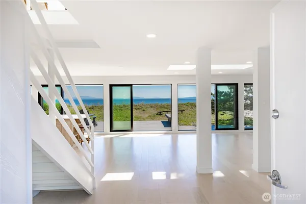 a living room with furniture large windows and a flat screen tv