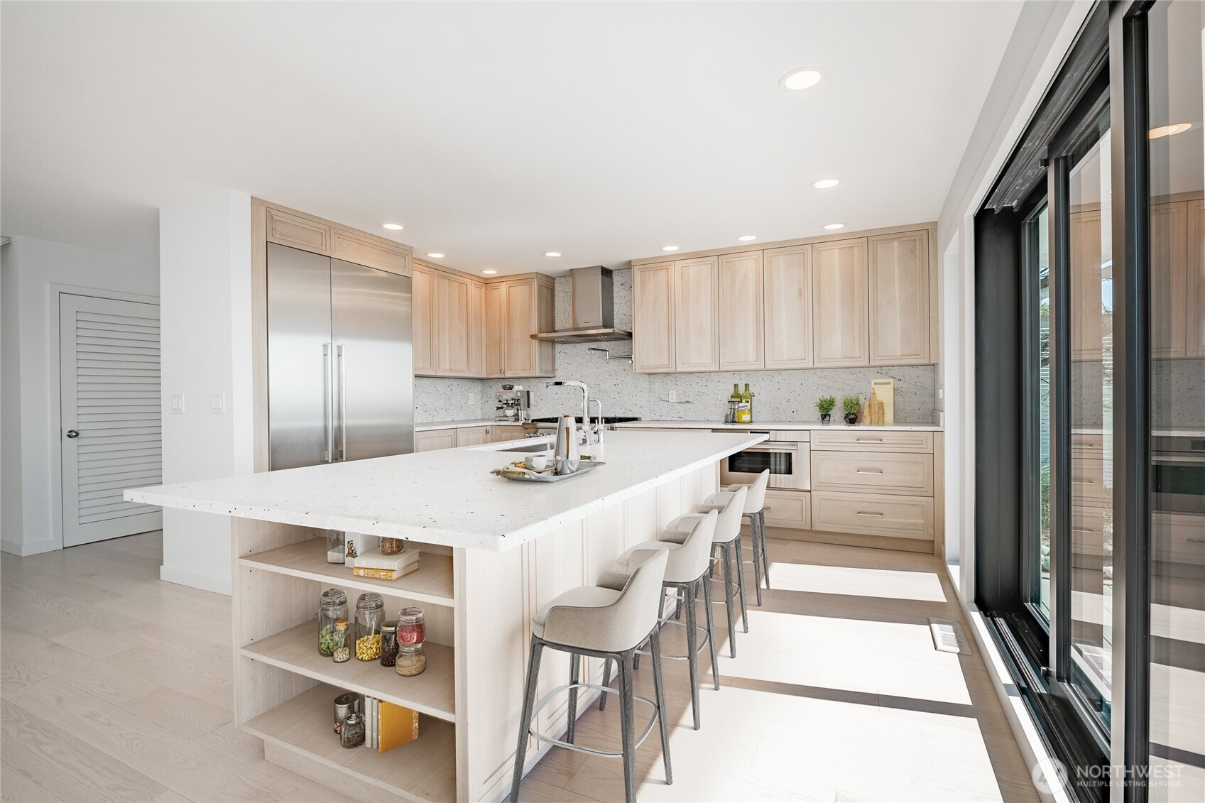 1613 Edwards Drive Point Roberts, WA 98281 - Photo 18 of 38 a kitchen with kitchen island a stove a refrigerator and a dining table with wooden floor