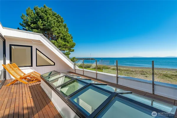 a view of balcony with wooden floor and a garden