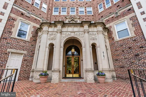 a front view of a building with garden