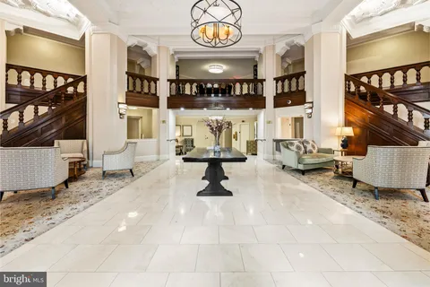 a living room with furniture and a wall painting