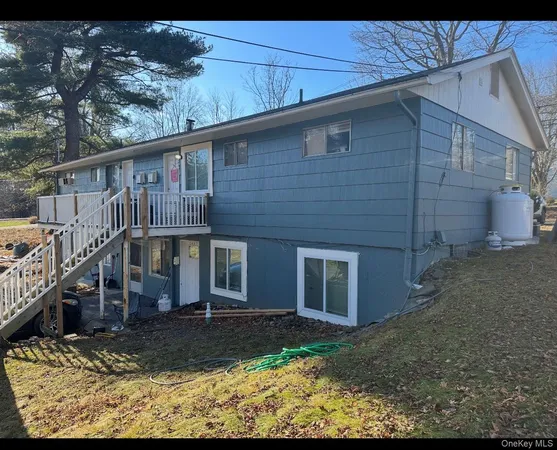 a brick house that has tree in front of it