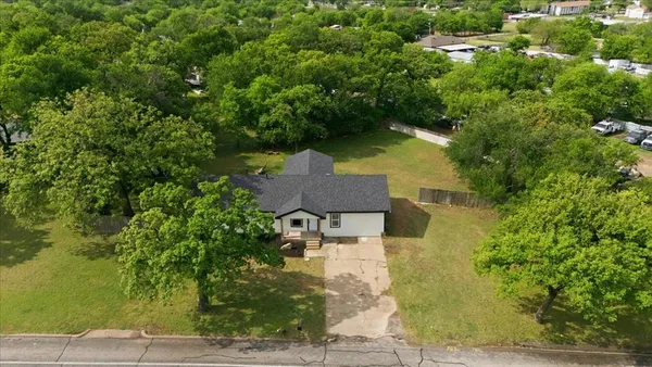 an aerial view of a house with yard swimming pool and outdoor seating