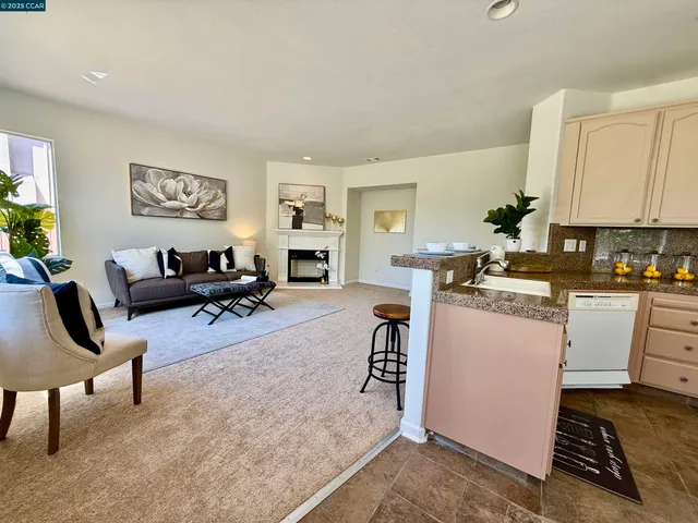 a living room with furniture a rug and a window