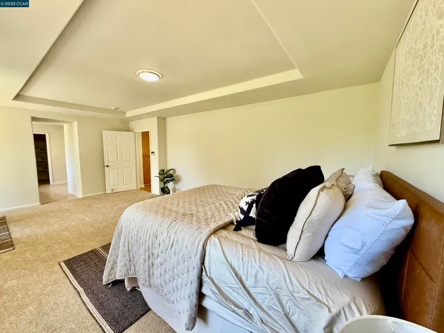 a bedroom with a bed and a potted plant