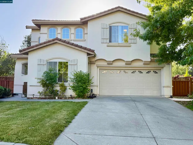 a front view of a house with a garden and plants